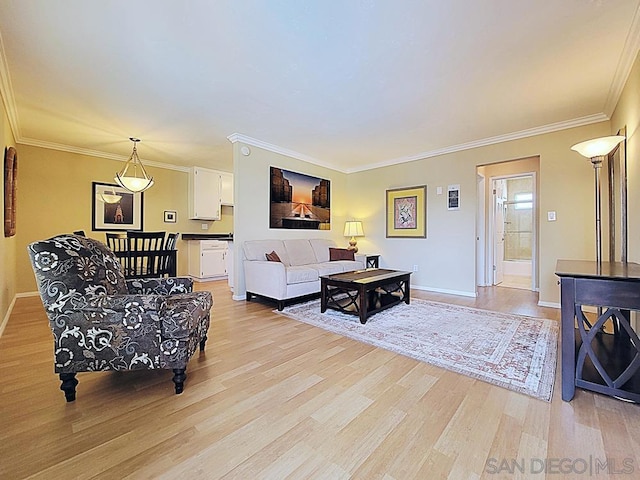 living room with crown molding and light wood-type flooring