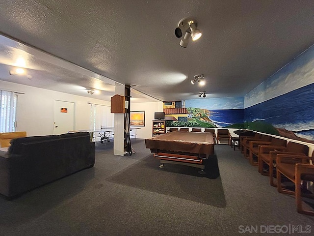 recreation room featuring pool table and a textured ceiling