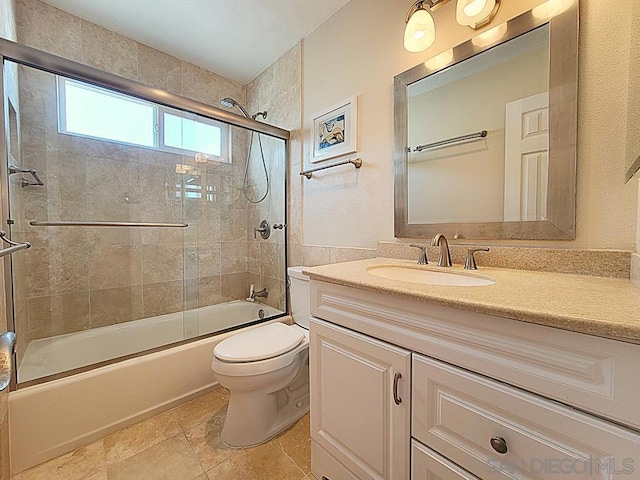 full bathroom with enclosed tub / shower combo, vanity, and toilet