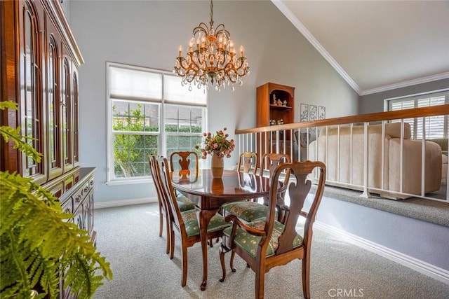 carpeted dining area with ornamental molding, high vaulted ceiling, and a chandelier