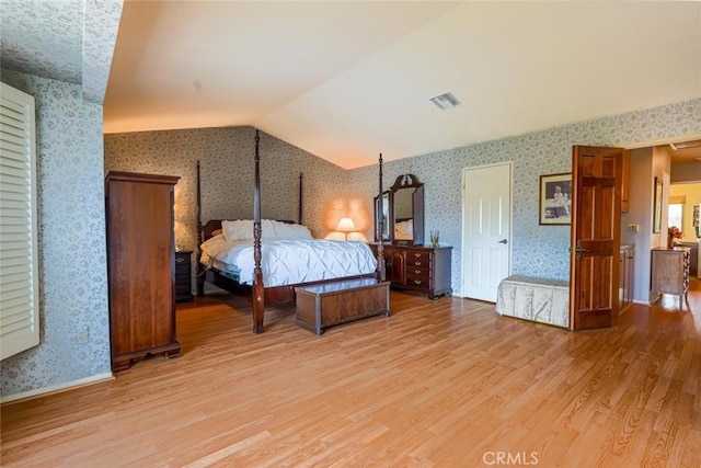 bedroom with light hardwood / wood-style floors and vaulted ceiling