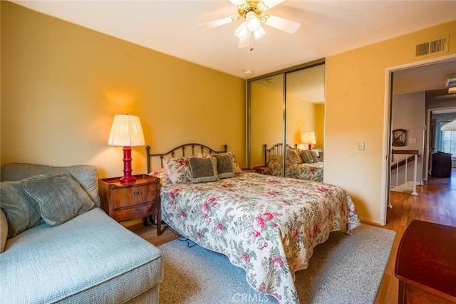 bedroom featuring ceiling fan, hardwood / wood-style floors, and a closet