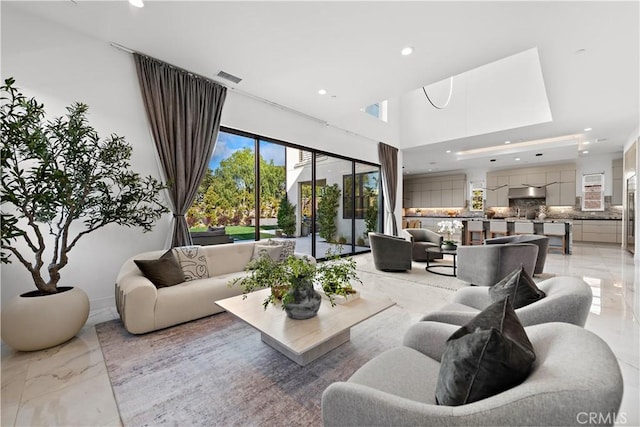 living room with marble finish floor, visible vents, and recessed lighting