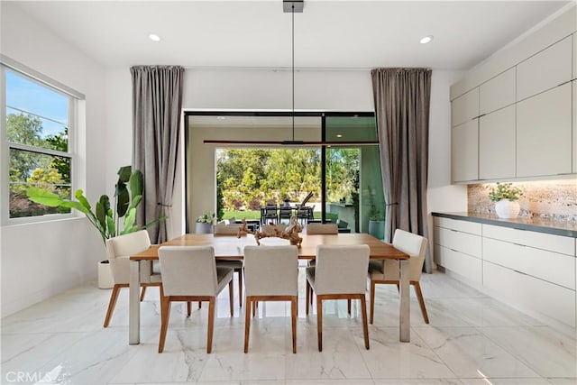 dining space featuring recessed lighting and marble finish floor