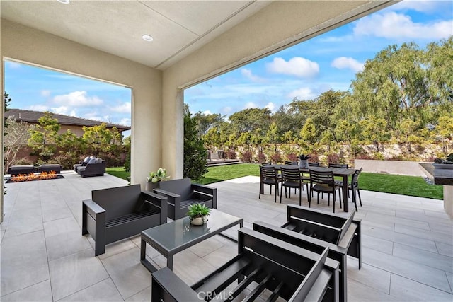 view of patio featuring an outdoor living space with a fire pit and outdoor dining space