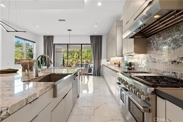 kitchen with under cabinet range hood, a sink, marble finish floor, appliances with stainless steel finishes, and backsplash