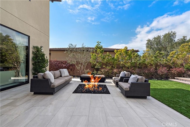 view of patio / terrace featuring an outdoor living space with a fire pit