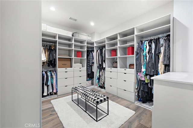 spacious closet featuring visible vents and wood finished floors