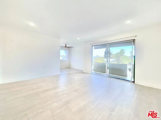 empty room with light hardwood / wood-style floors and ceiling fan