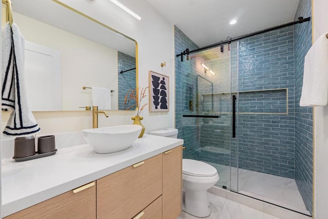 bathroom with a shower with door, vanity, and toilet