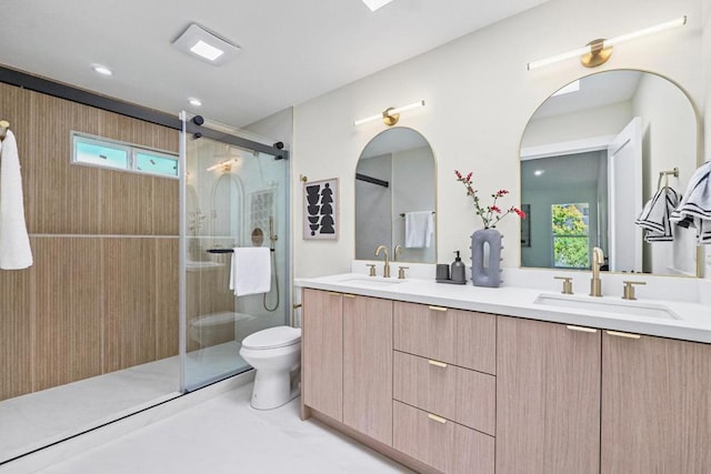 bathroom featuring vanity, toilet, and walk in shower