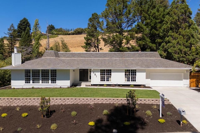 ranch-style house with a garage and a front yard