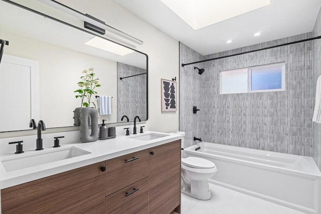 full bathroom featuring tiled shower / bath combo, vanity, tile patterned flooring, and toilet