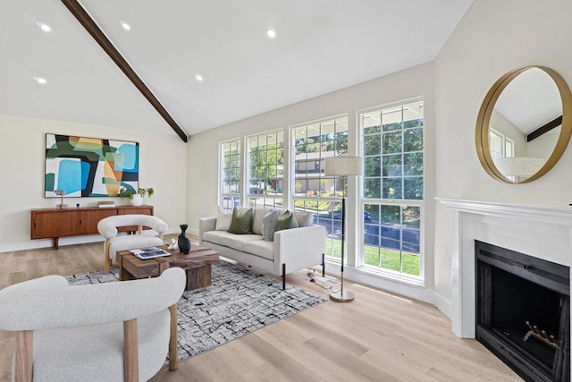 living room featuring plenty of natural light, high vaulted ceiling, and light wood-type flooring