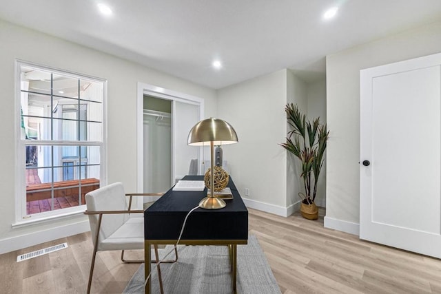 office with light hardwood / wood-style flooring