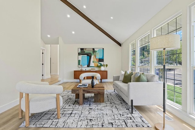 living room featuring high vaulted ceiling and light wood-type flooring