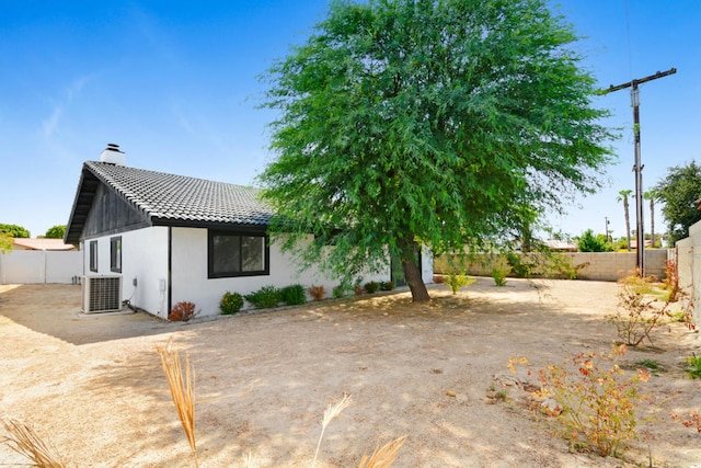 rear view of property featuring central air condition unit