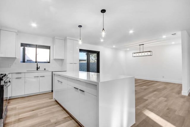 kitchen with white cabinetry, a center island, and pendant lighting