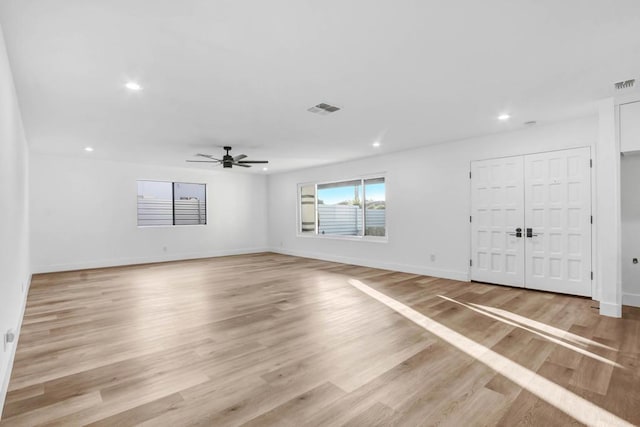 unfurnished room with ceiling fan and light wood-type flooring