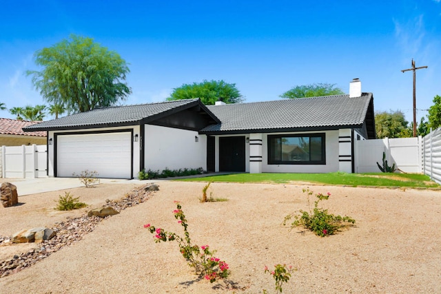 ranch-style home featuring a garage