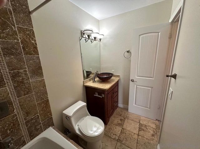 bathroom featuring vanity, a bath, and toilet