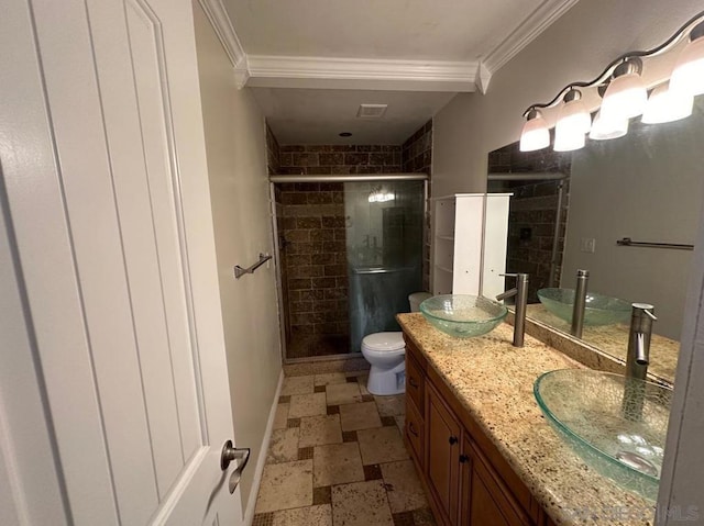 bathroom with ornamental molding, toilet, a shower with shower door, and vanity