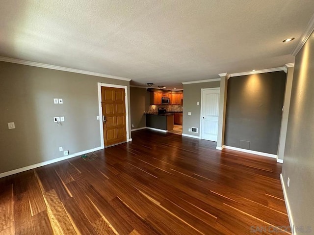 unfurnished living room featuring dark wood-type flooring, ornamental molding, and a textured ceiling