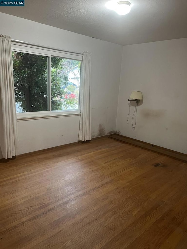 unfurnished room featuring hardwood / wood-style floors