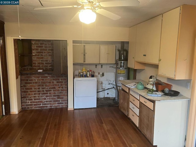 kitchen with gas water heater, brick wall, dark hardwood / wood-style floors, washer / dryer, and cream cabinetry