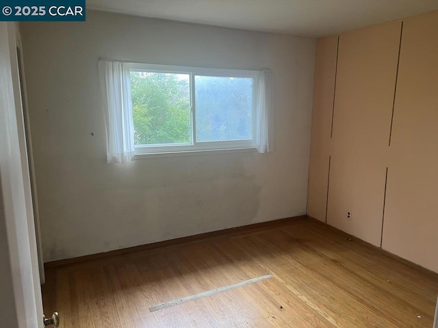 unfurnished bedroom featuring light wood-type flooring