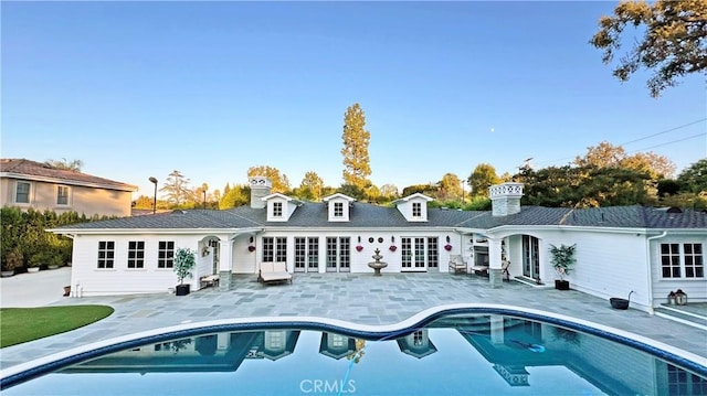 back of property featuring a patio and french doors