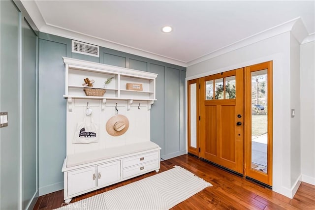 mudroom with ornamental molding and dark wood-type flooring