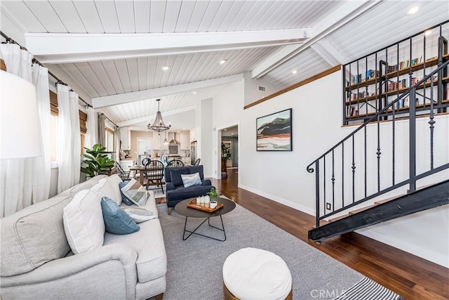 living room featuring dark hardwood / wood-style flooring, a chandelier, and lofted ceiling with beams