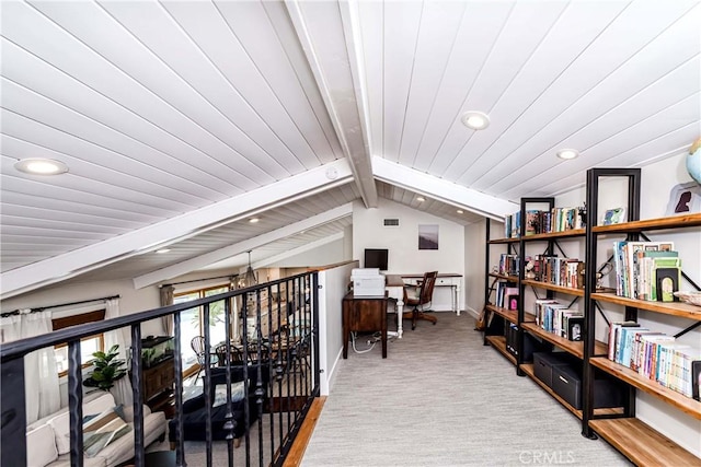 interior space featuring lofted ceiling with beams and carpet