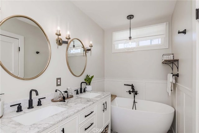 bathroom with vanity and a washtub