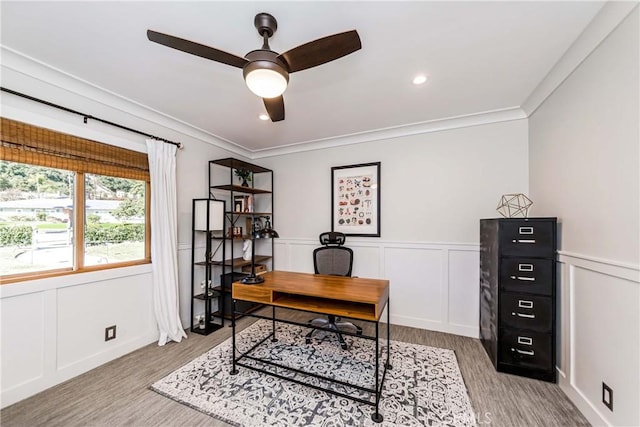 home office with crown molding, ceiling fan, and light hardwood / wood-style flooring