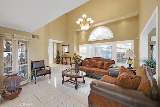 living room featuring a notable chandelier, high vaulted ceiling, and light tile patterned flooring