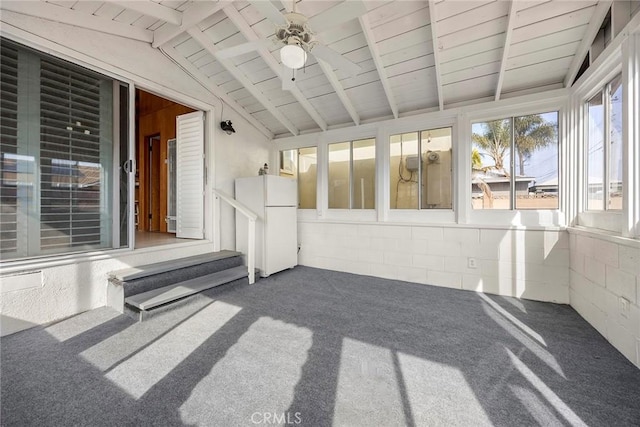 unfurnished sunroom with lofted ceiling with beams, wooden ceiling, and ceiling fan