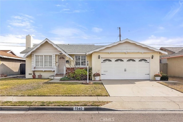 ranch-style house featuring a garage and a front yard