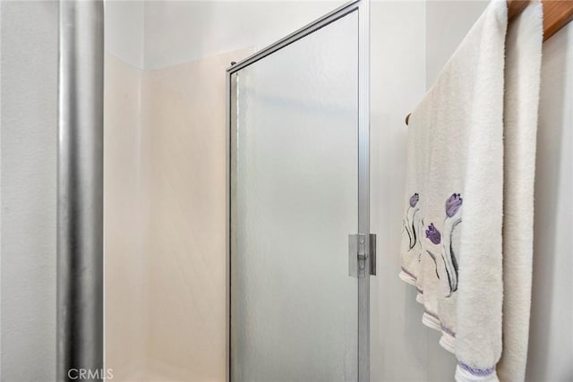 bathroom with a shower with door