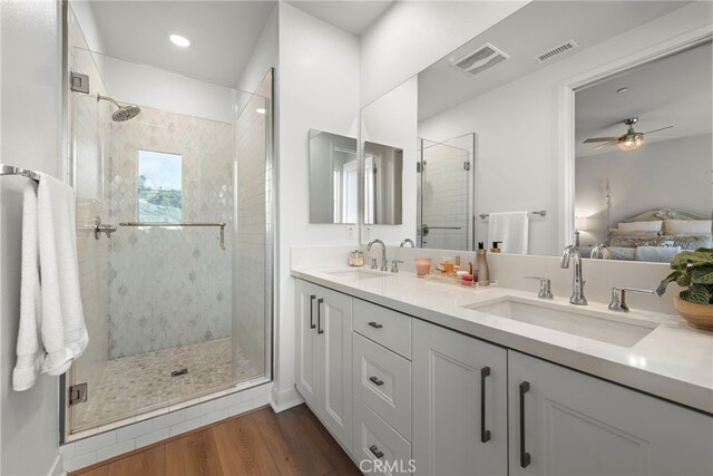 bathroom with vanity, an enclosed shower, wood-type flooring, and ceiling fan