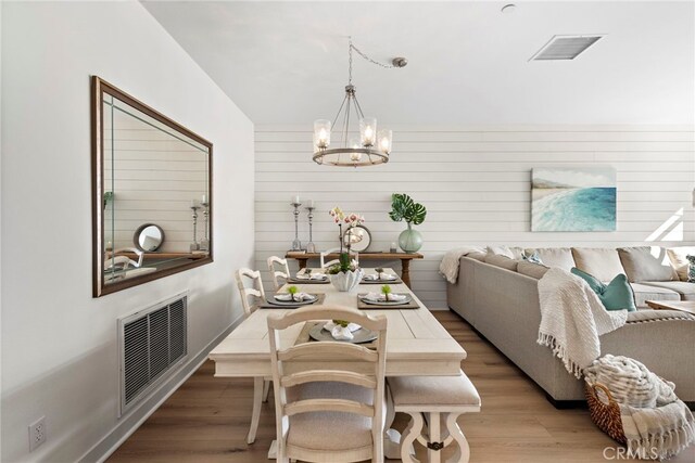 dining space with an inviting chandelier and light wood-type flooring