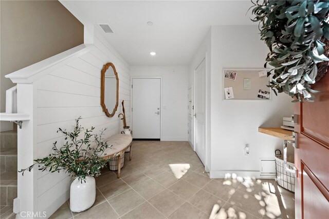 foyer entrance with light tile patterned flooring