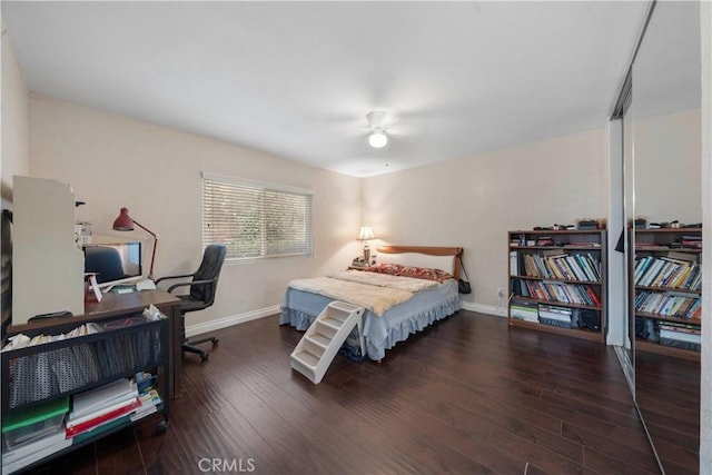 bedroom with dark wood-type flooring