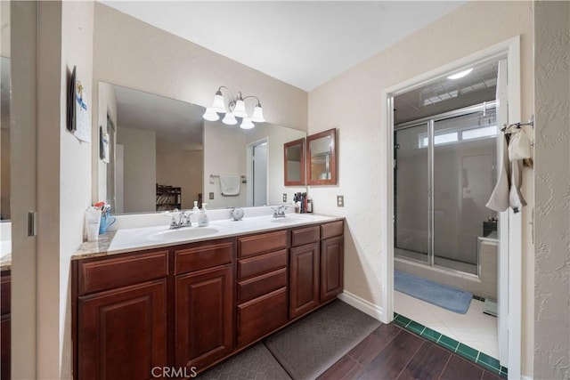 bathroom featuring walk in shower and vanity