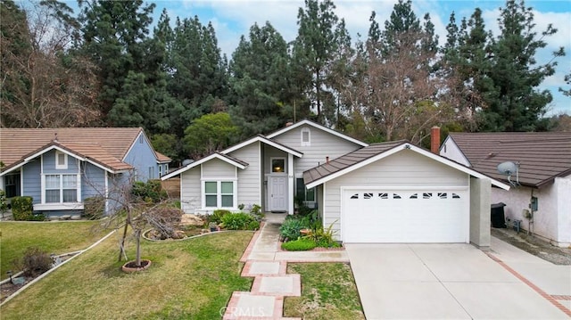 view of front of property featuring a garage and a front lawn