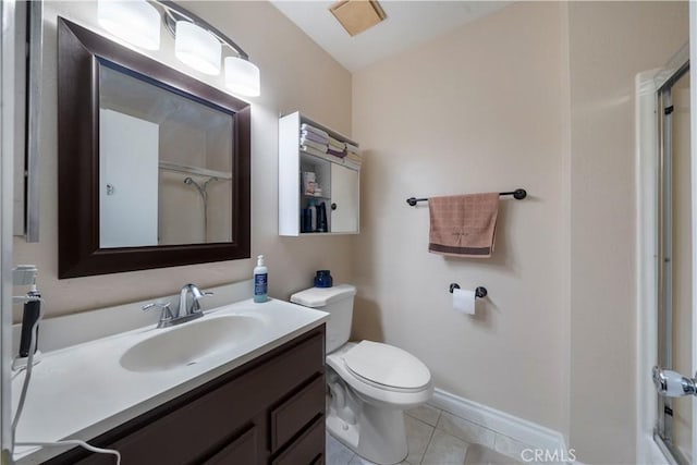 bathroom featuring tile patterned floors, vanity, toilet, and a shower with shower door