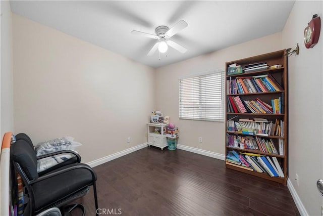 living area featuring dark hardwood / wood-style flooring and ceiling fan