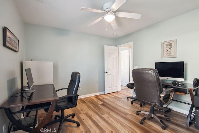 office with ceiling fan and light hardwood / wood-style floors