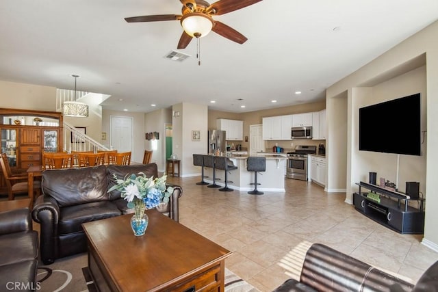 tiled living room featuring ceiling fan